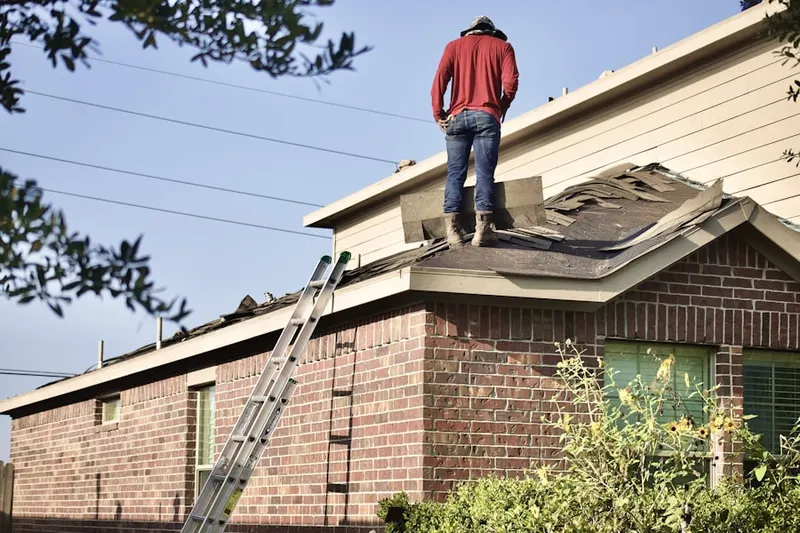 Professional roofer working on a residential roof in Lotus